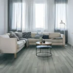 Living room with a cream sofa and distressed gray bamboo flooring.