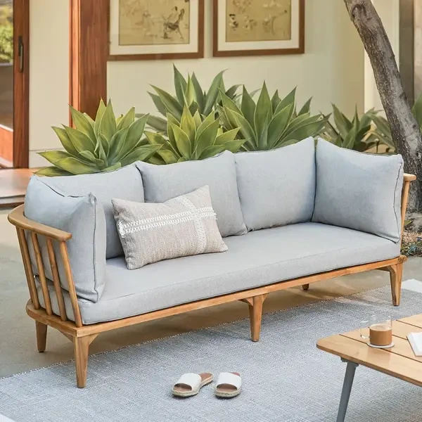 Mid-century style outdoor couch with a light wood frame