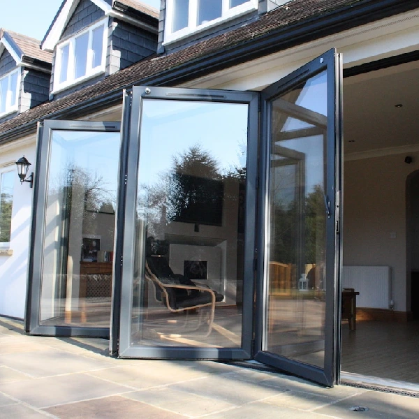 Modern aluminum bi-fold doors open wide onto a patio