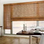 Natural woven bamboo blinds covering a large dining window