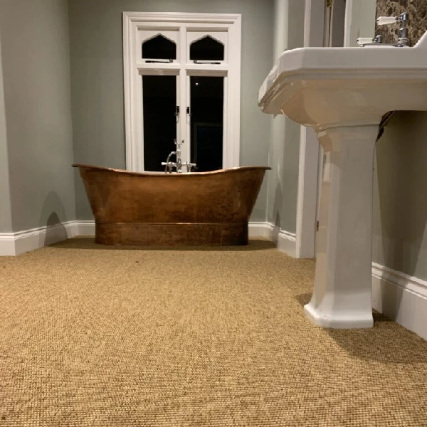 Neutral tan sisal carpet in luxury bathroom