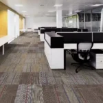 Office floor covered with multi-colored patterned modular carpet tiles