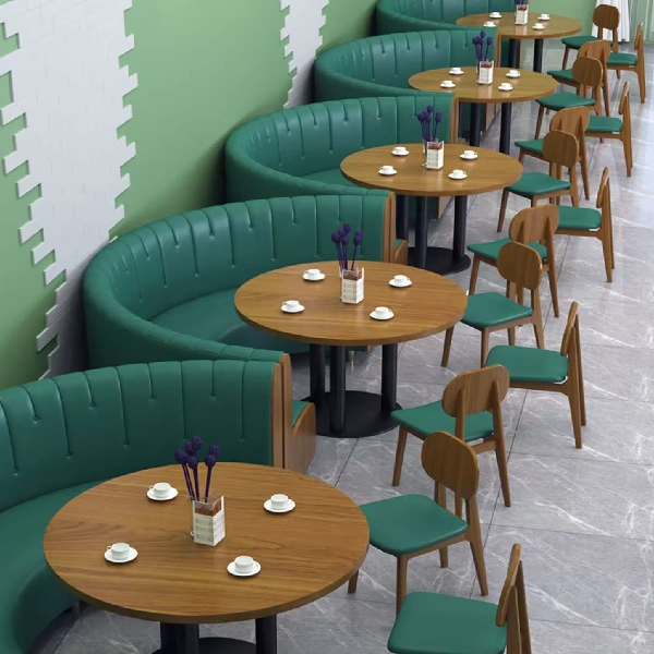 Repeating curved green faux leather restaurant booths