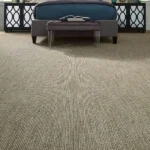 Wall-to-wall light beige carpet with a textured, tightly ribbed linear pattern