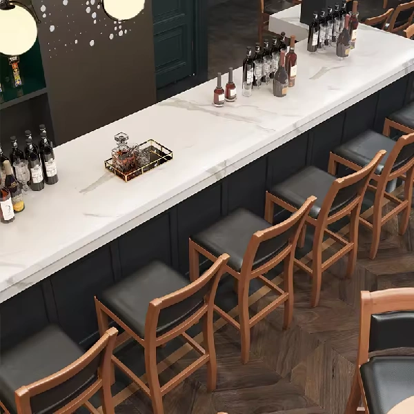 White marble-look countertop over a dark paneled bar