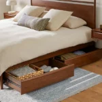 Wooden platform bed with under-bed storage drawers pulled out