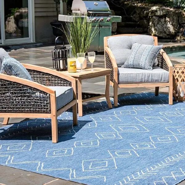 blue outdoor area rug with white geometric diamond patterns