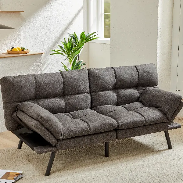 dark gray tufted sofa bed with metal legs