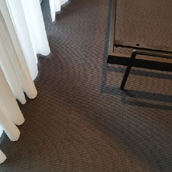 dark grey-brown boucle carpet with a subtle linear texture