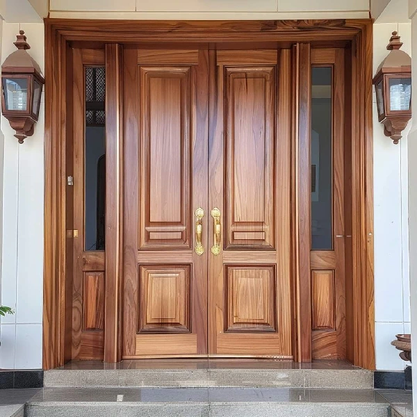 double wooden entrance doors with panels and ornate gold handles