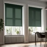 forest green roller blinds partially drawn over tall windows in a room