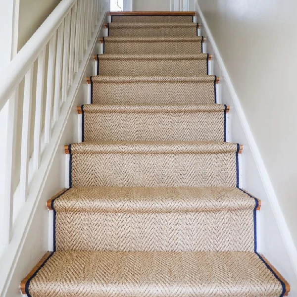 jute stair runner with a chevron pattern and dark blue edging