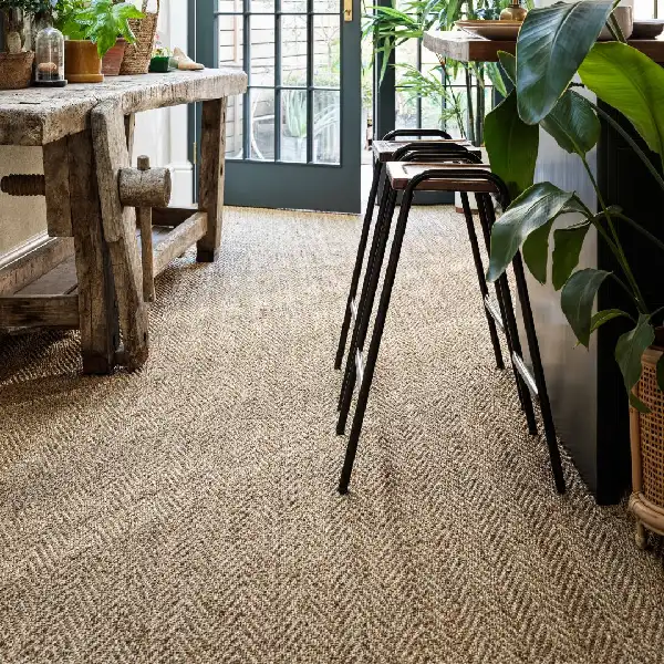 light brown sisal carpet featuring a distinct chevron pattern