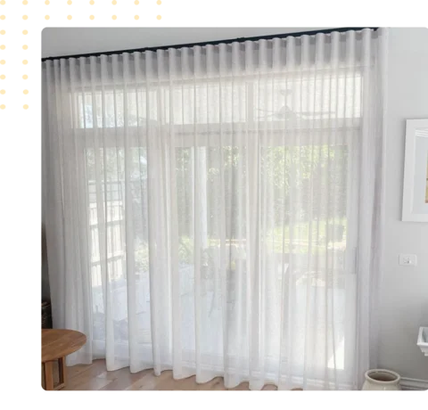 sheer wave fold curtains covering a glass door
