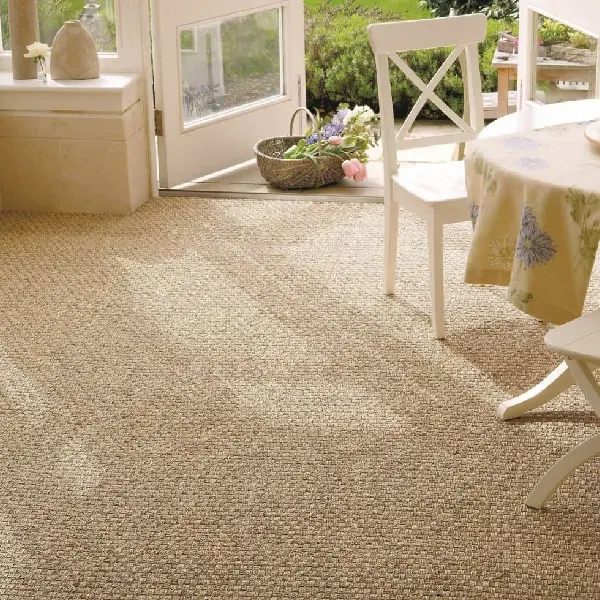 textured sisal wall-to-wall carpet in a bright room with a white table