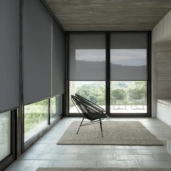windows covered by dark grey roller blinds