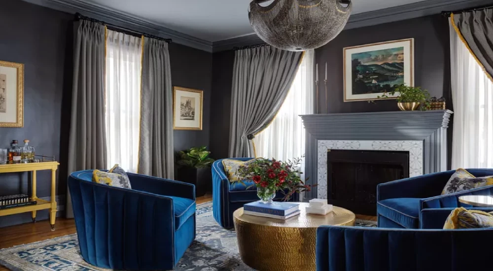 Dark wall color room with grey curtains and fully furnished